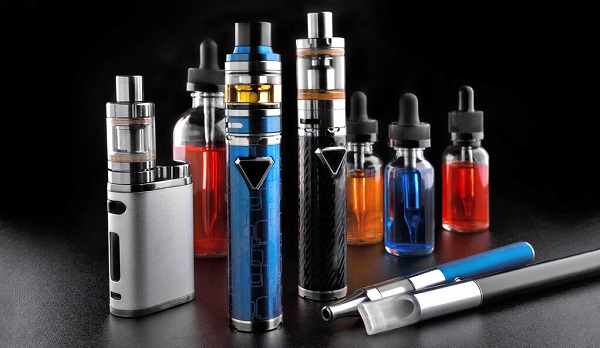 Electronic Cigarettes And Bottles With Vape Liquid On Black Background